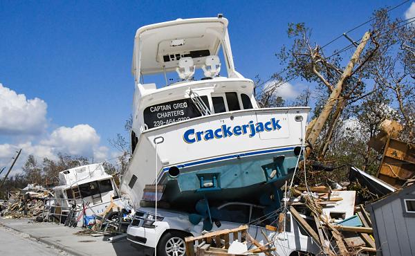 Crackerjack rests on top of an SUV in the aftermath of Hurricane Ian, which left this Fort Myers marina destroyed.